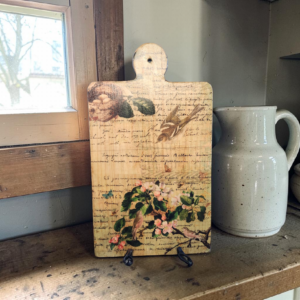 Vintage-Inspired Wood Cutting Board with Colorful Flowers and Handwritten Cursive Writing.
